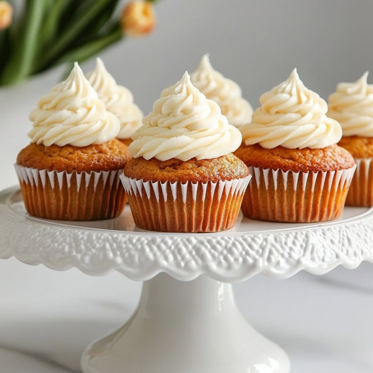 Bunch of carrot cupcake sitting on top of cake tray.