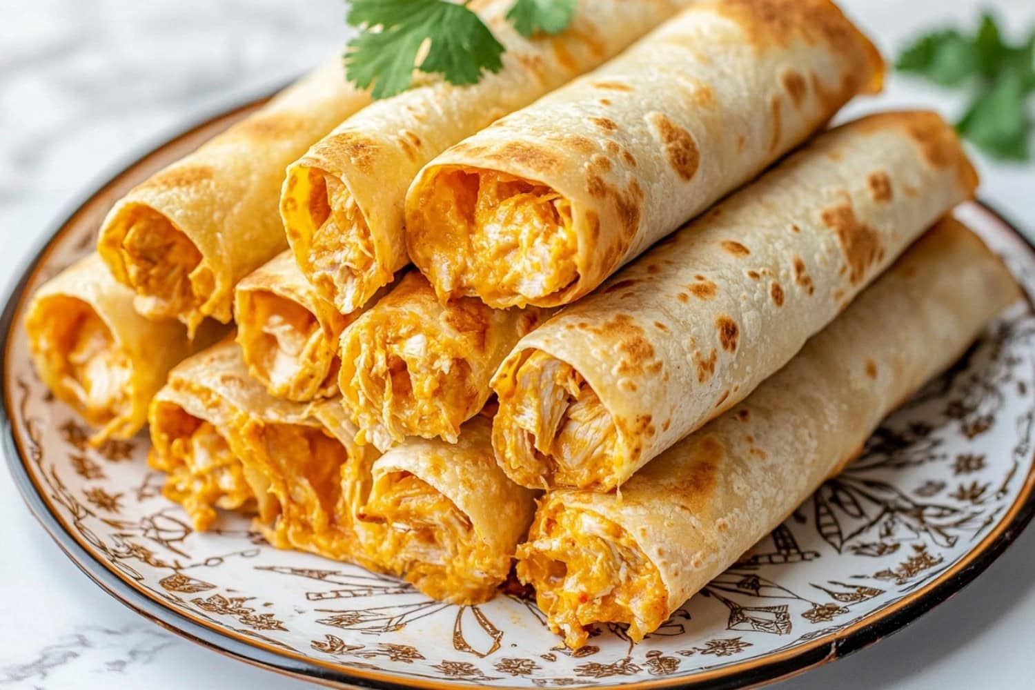 A close-up view of crispy chicken taquitos on a plate.