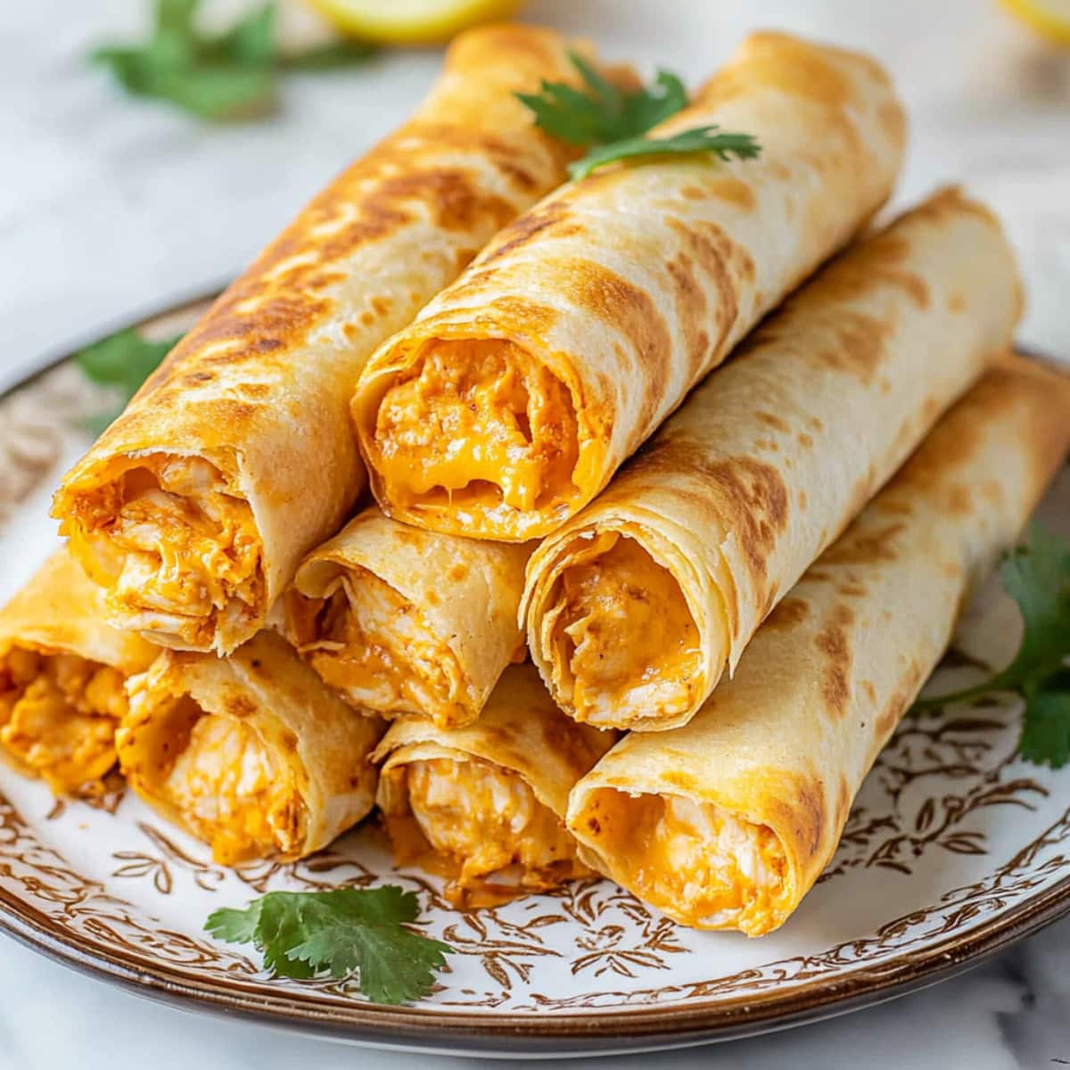 A stack of crispy taquitos with shredded chicken and melted cheese filling in a plate.