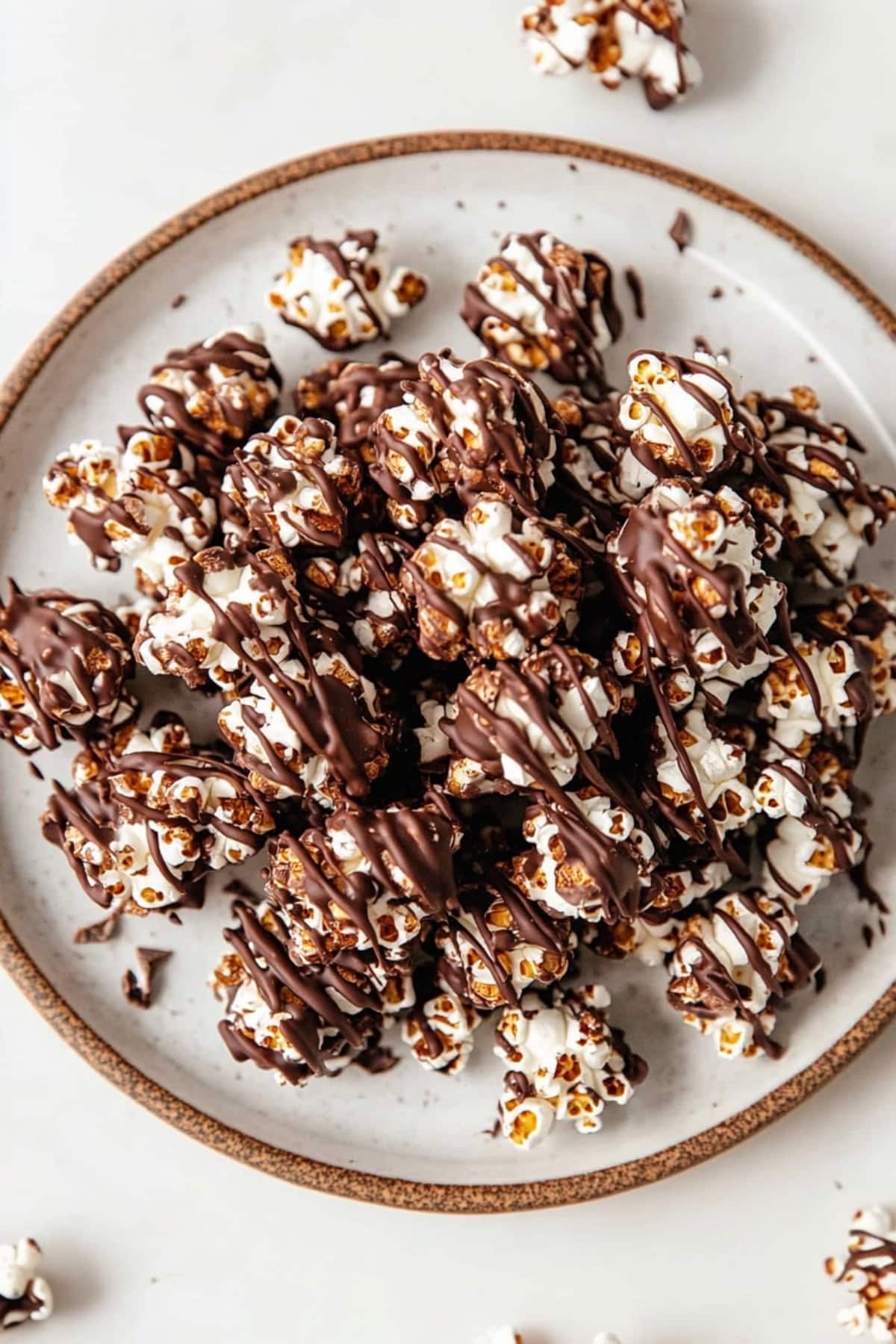 A close-up of chocolate covered popcorn on a plate.