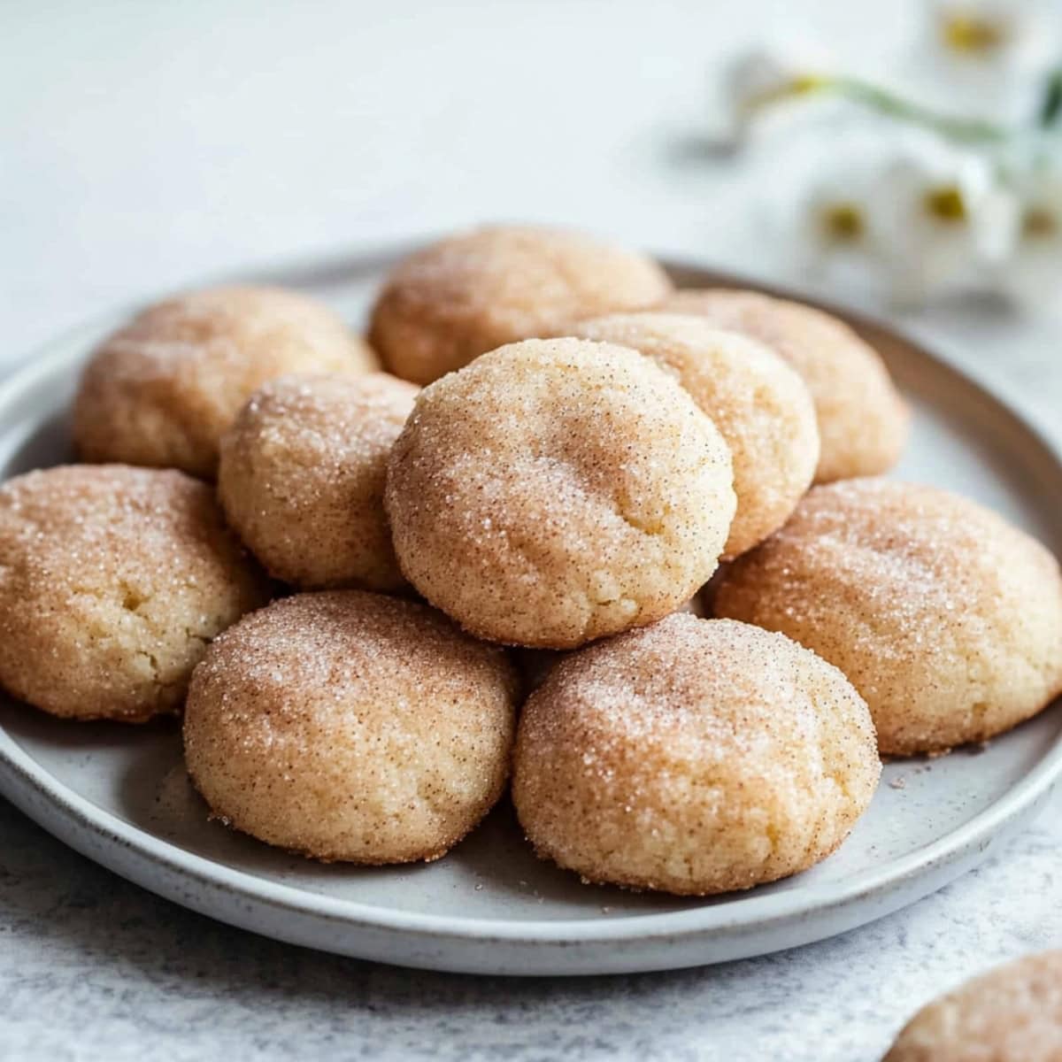 Bunch of cream cheese snickerdoodles served on a plate.