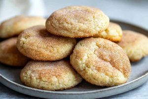 Bunch of soft cream cheese snickerdoodles biscuits served in a plate.