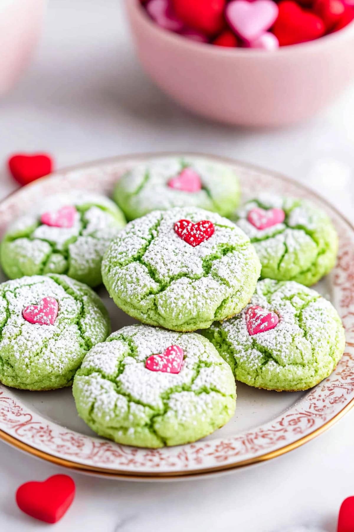 Bunch green colored cookies dusted with powdered sugar.