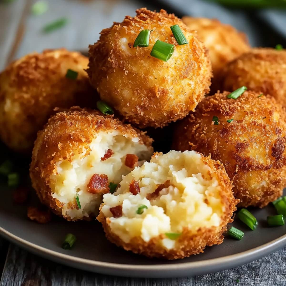 Crispy and creamy bunch of loaded mashed potato bites served in a plate.