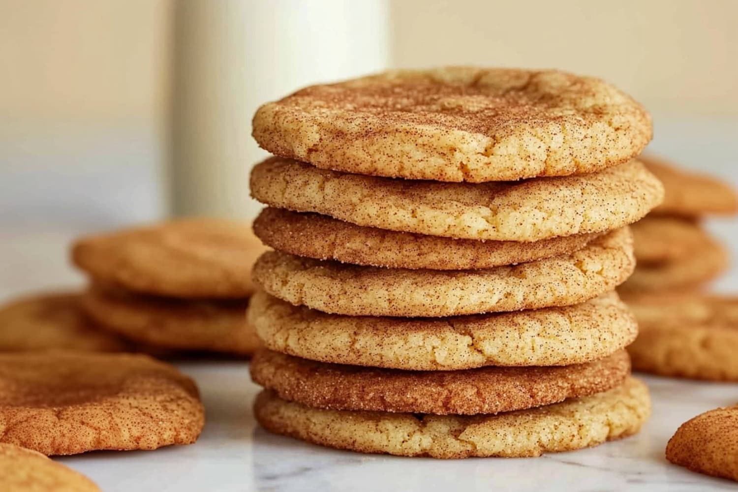 A stack of maple snickerdoodles, served with milk.