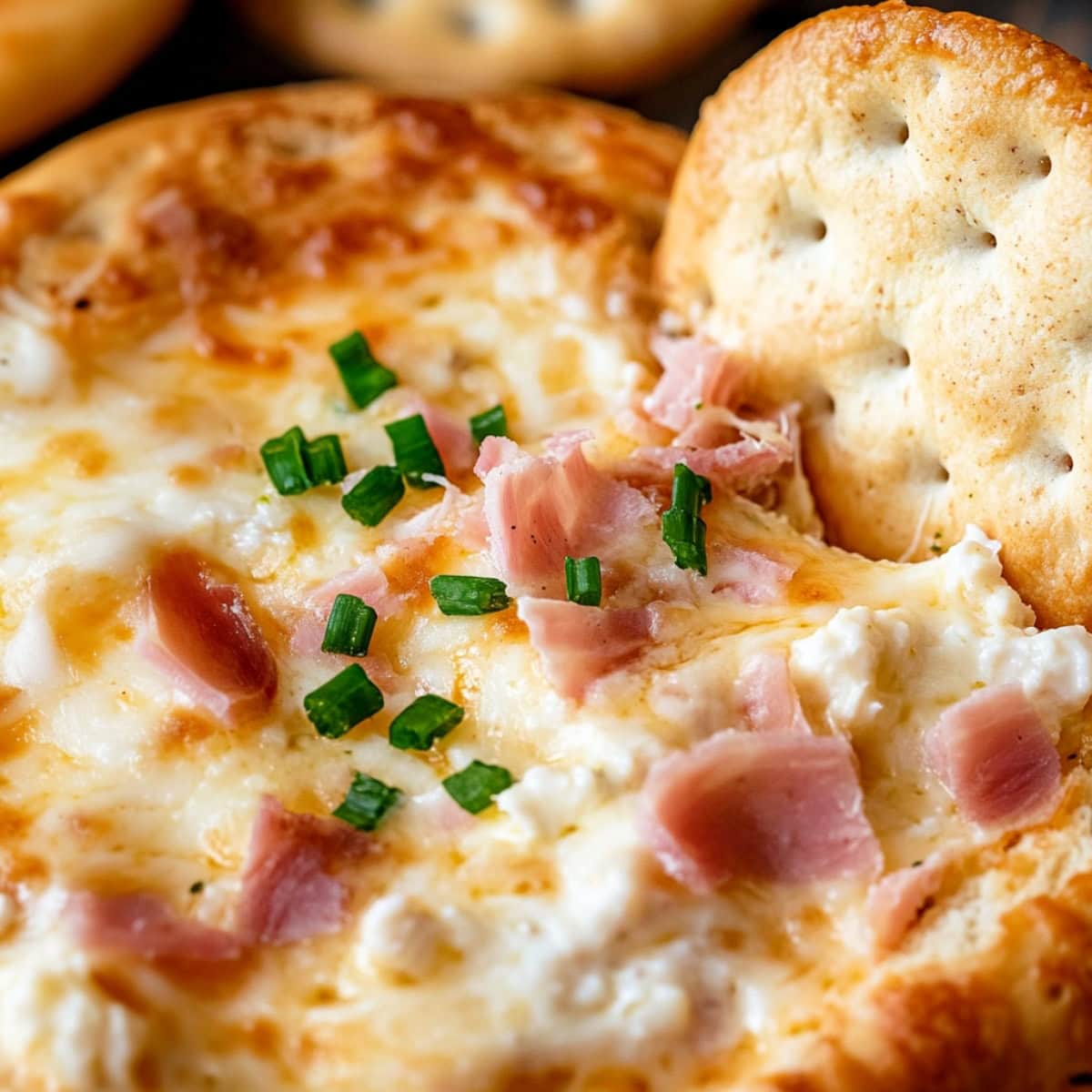 Close-up of cheesy Mississippi sin dip inside a hollow bread loaf.