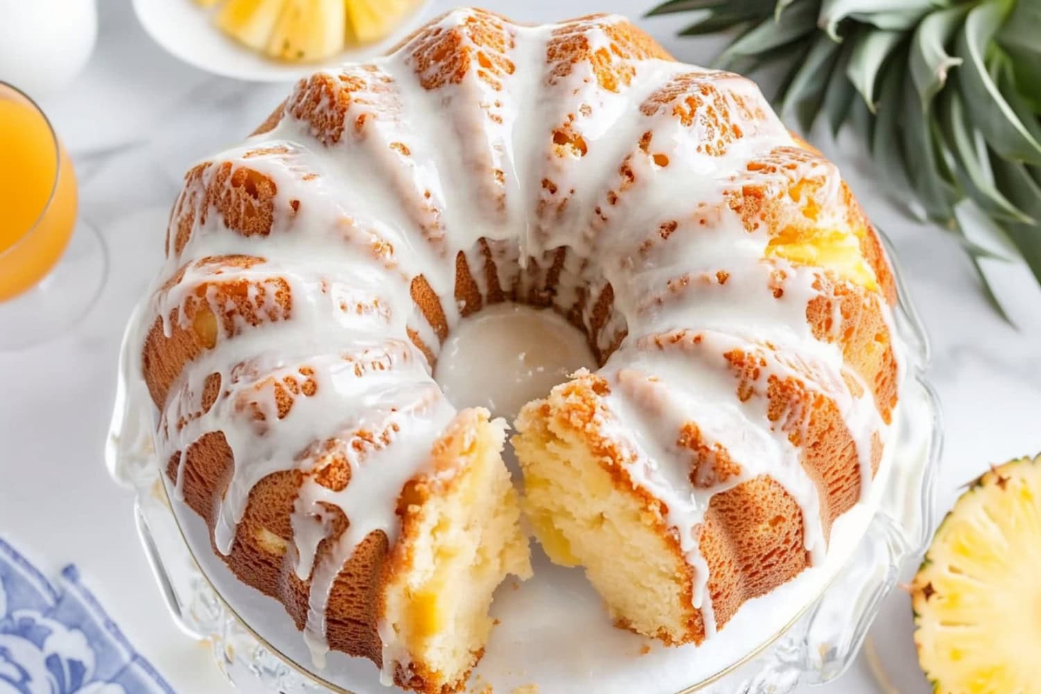 Slice missing pineapple pound cake drizzled with sugar glaze on top served on a white plate.