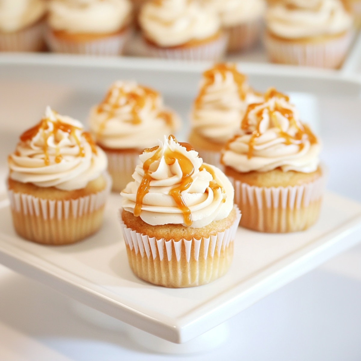 Salted caramel cupcakes on a square cake stand