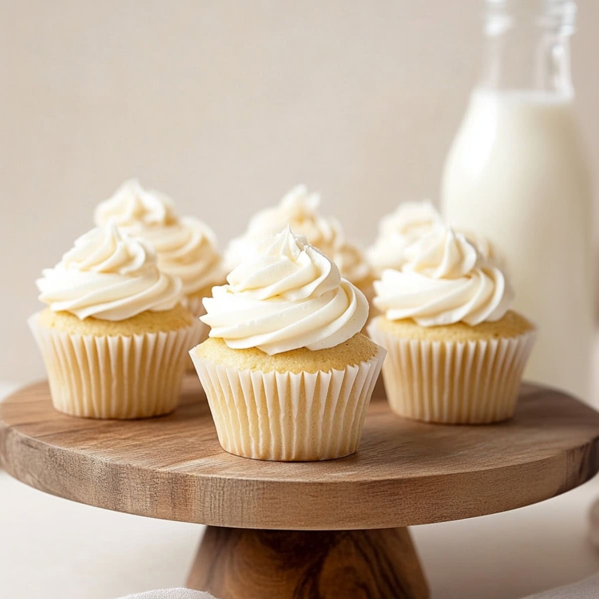 White chocolate cupcakes on a wooden cake stand