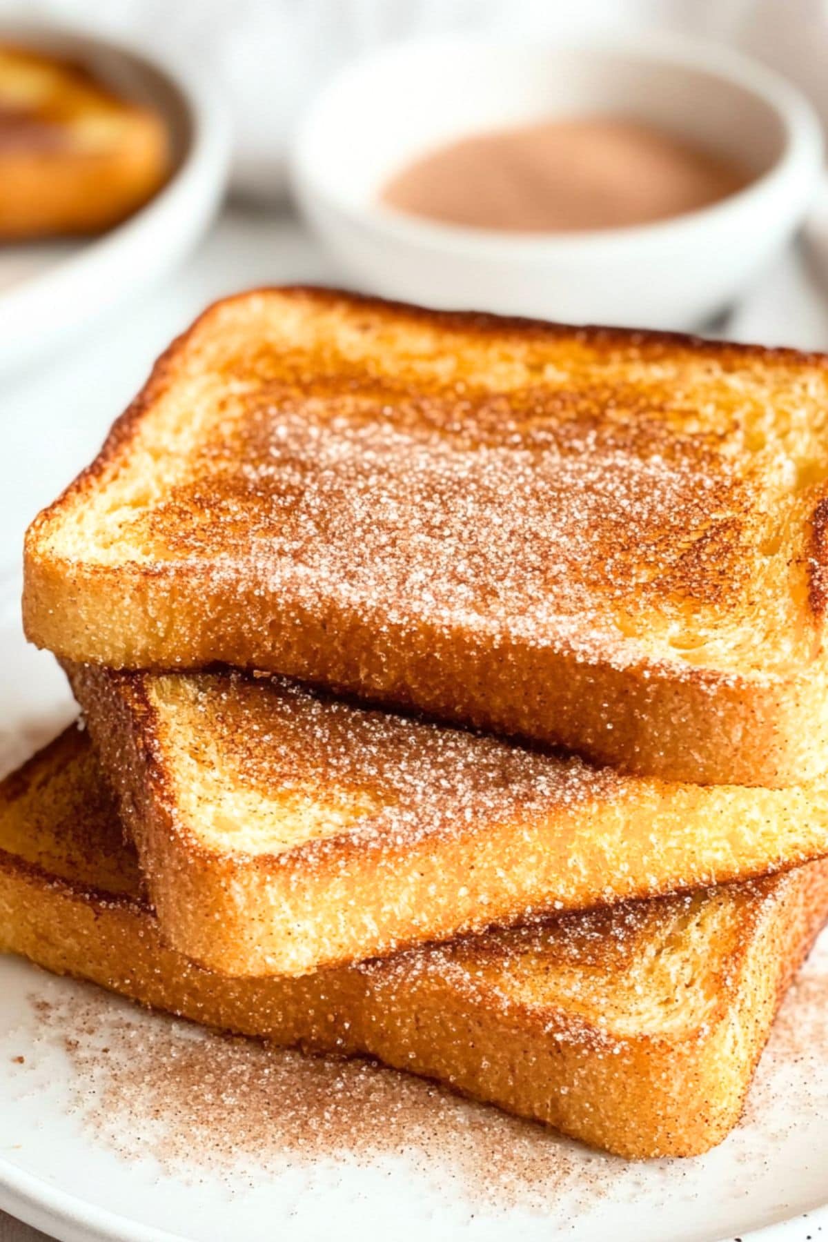 Sliced cinnamon spiced toast bread served in a white plate.