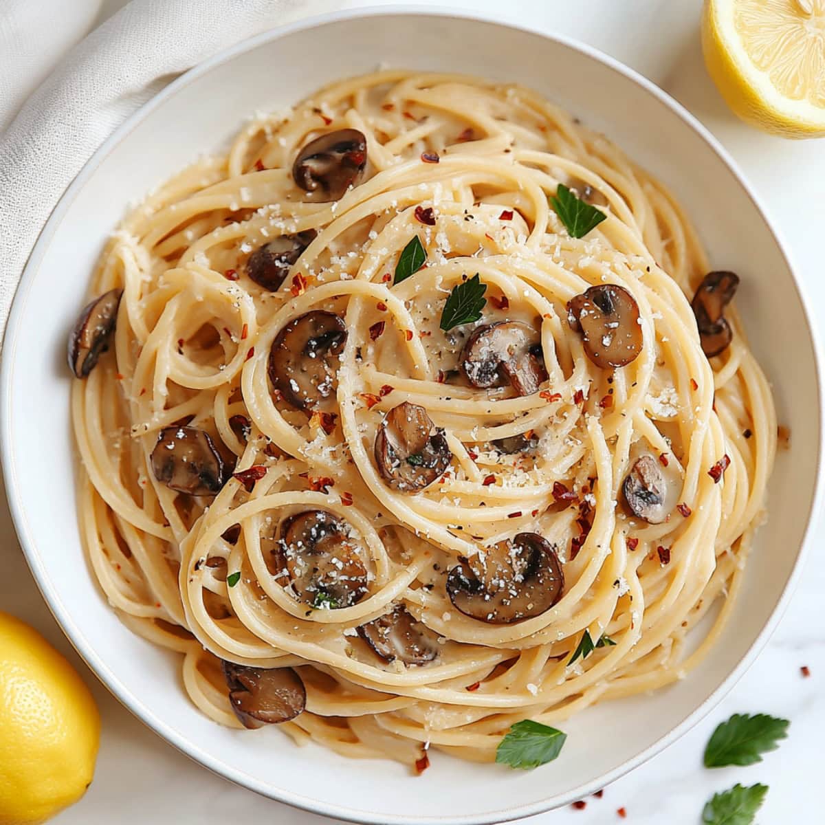Mushroom pasta with miso paste, garnished with parmesan, red pepper flakes and chopped parsley