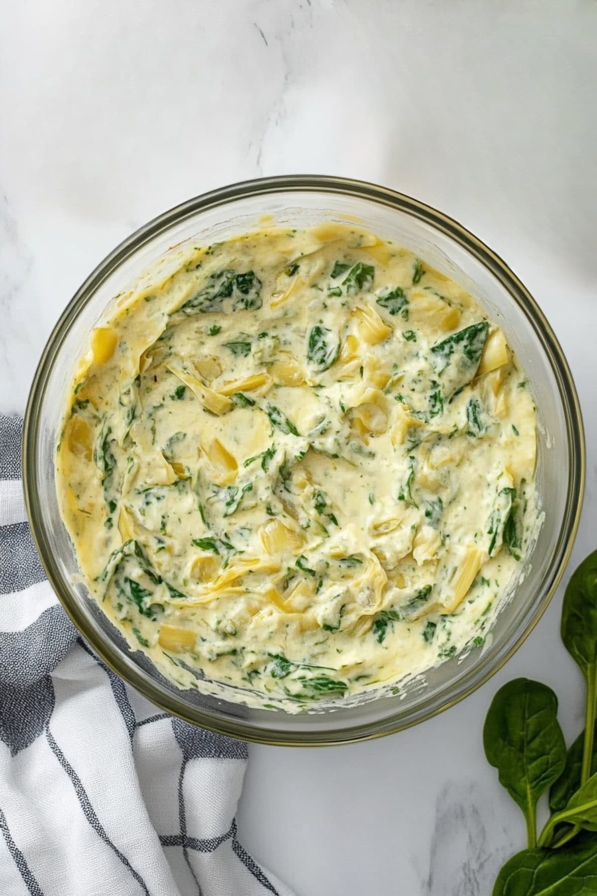 Artichokes and spinach in a glass bowl.