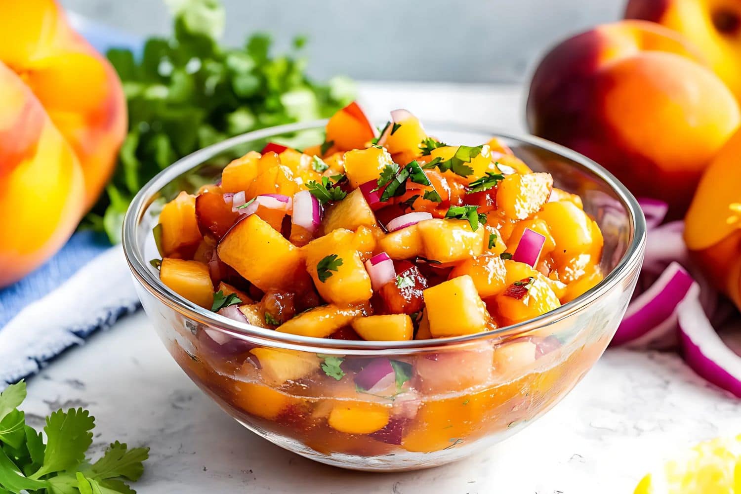 Peach salsa mix in a glass bowl.