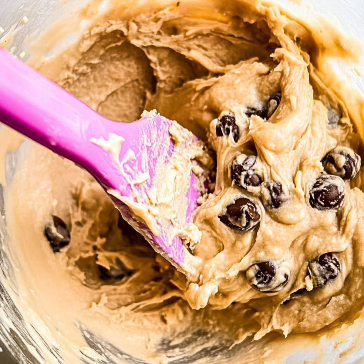 Peanut butter chocolate chip cookie batter in a mixing bowl 