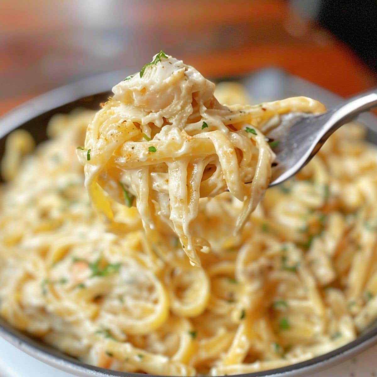 Forkful of creamy alfredo with lumps of crab meat