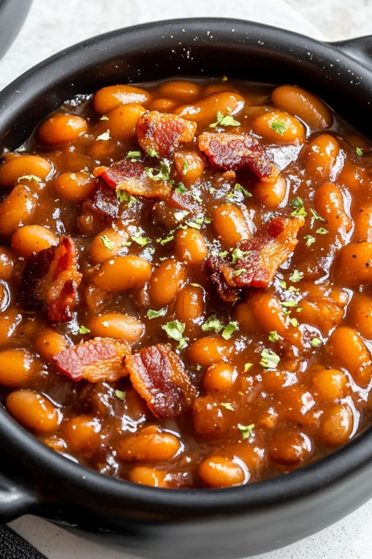 Baked beans in a black bowl.  