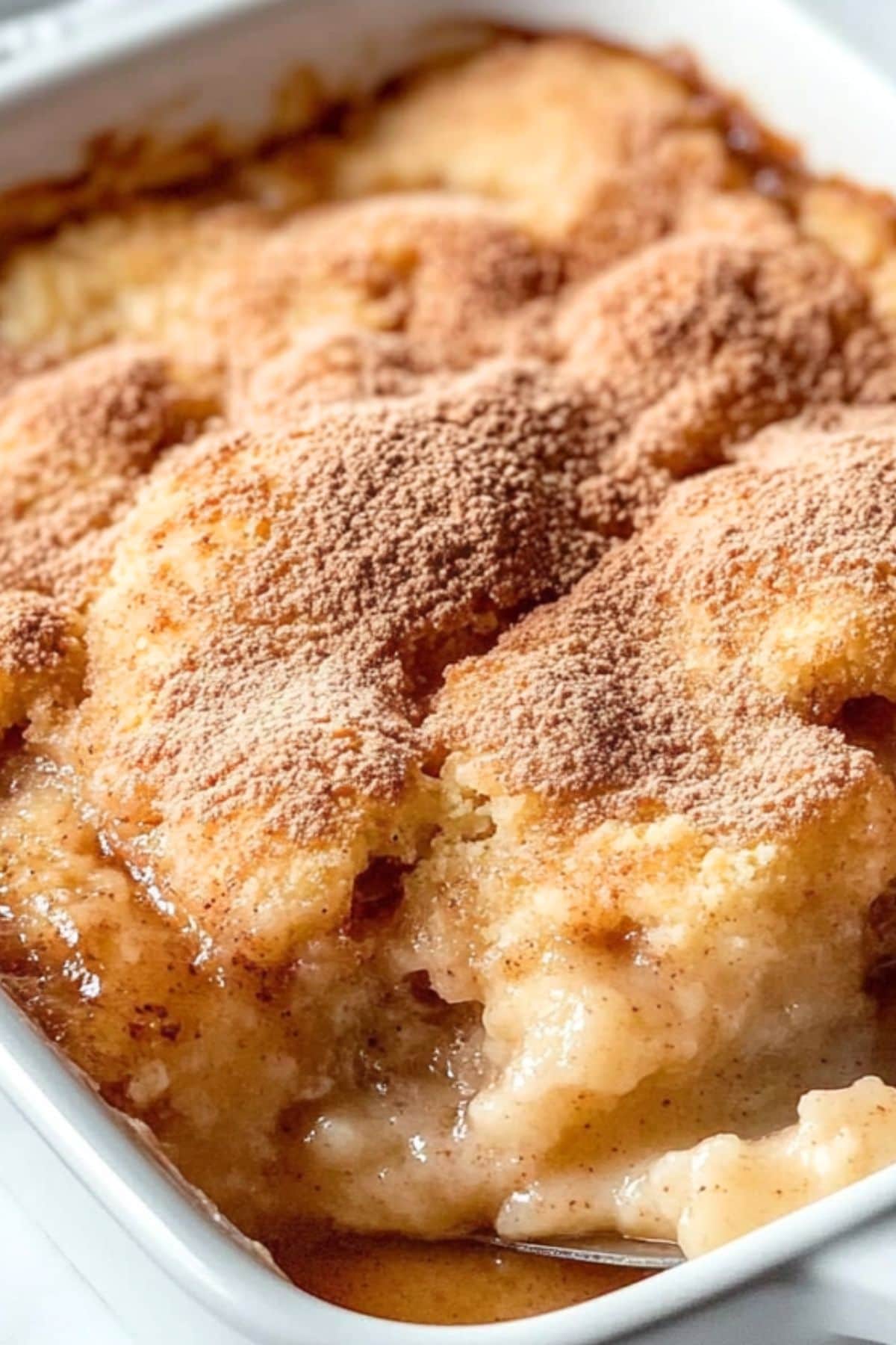 Butter snickerdoodle cobbler in a rectangular white baking dish.