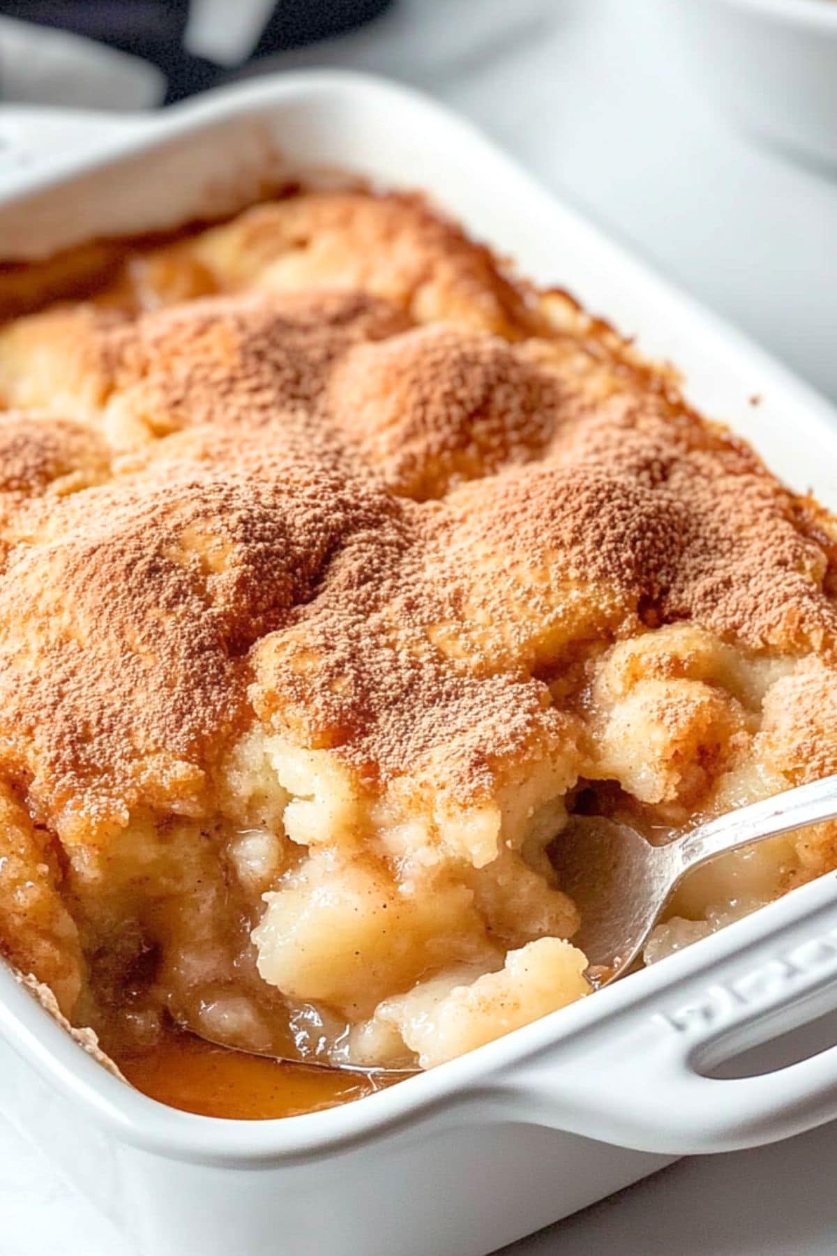 Snickerdoodle cobbler sprinkled with cinnamon baked in a rectangular baking dish.