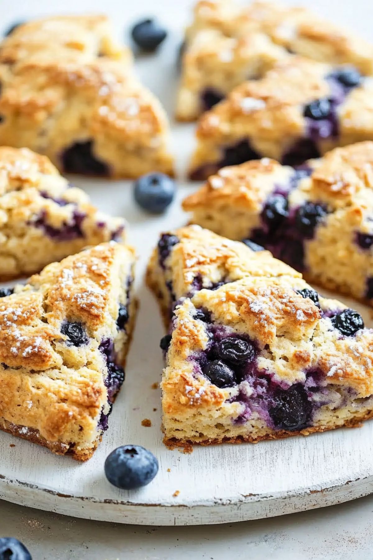 Blueberry scones on a round surface.