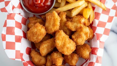An overhead of copycat Chick-Fil-A chicken nuggets with fries and ketchup.