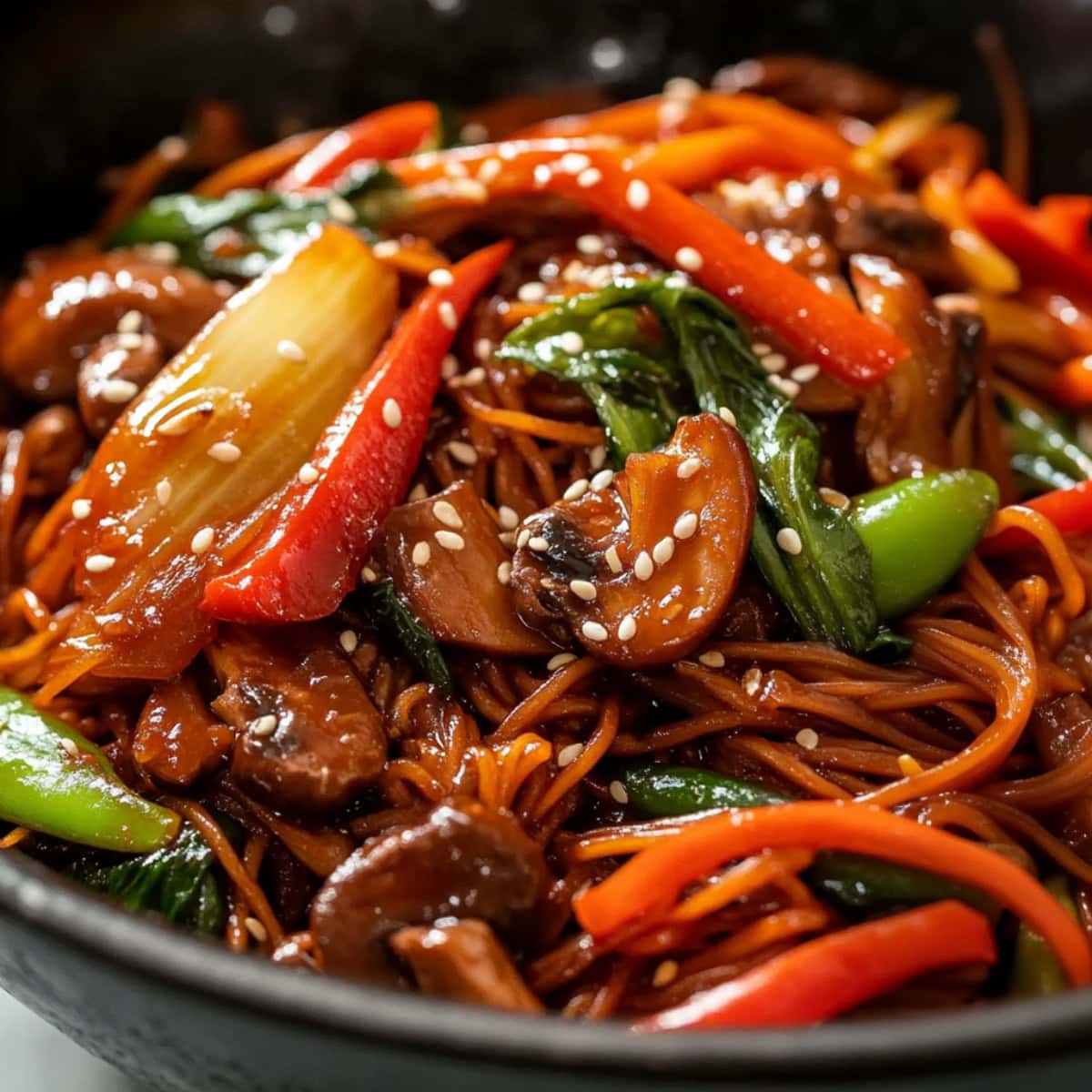 Savory and saucy homemade lo mein with fresh vegetables in a bowl.