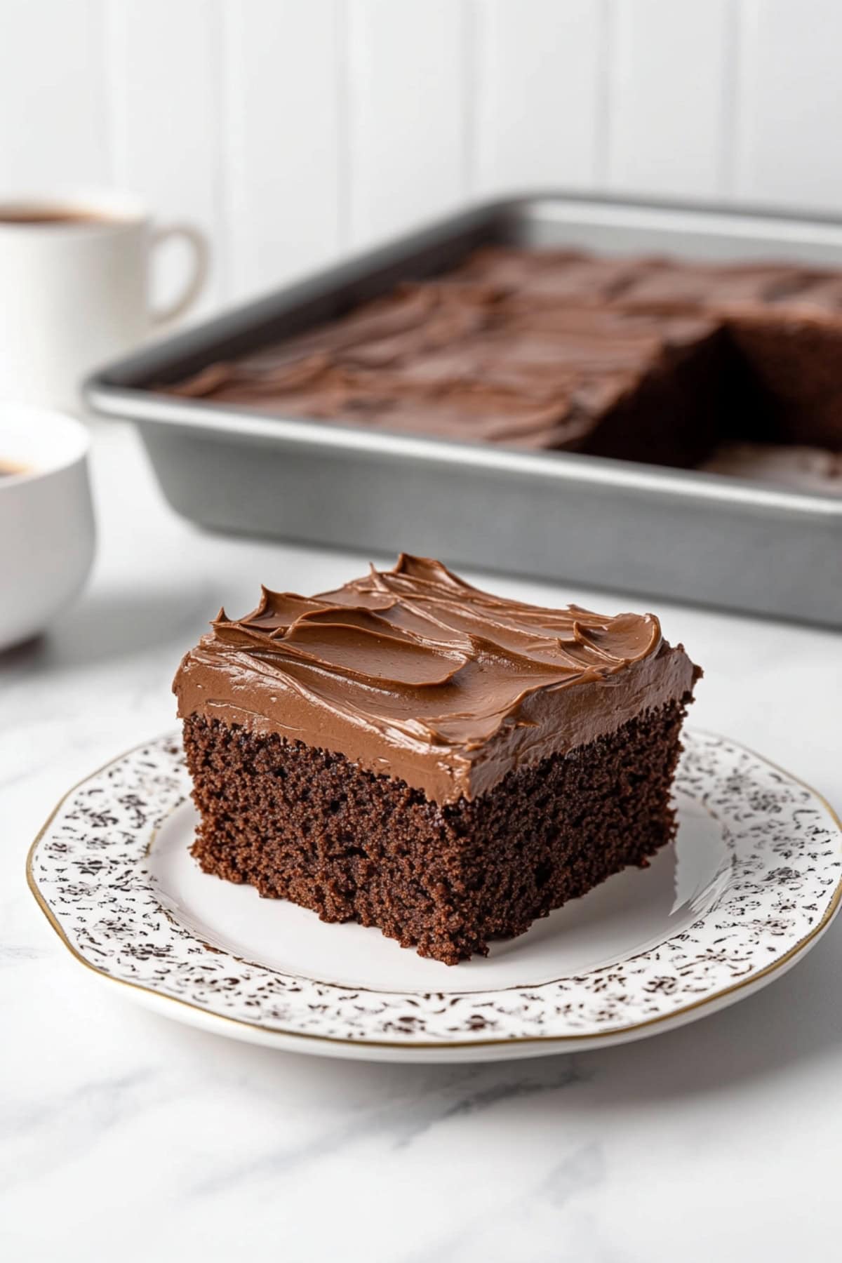 A freshly baked chocolate buttermilk cake on an elegant plate.