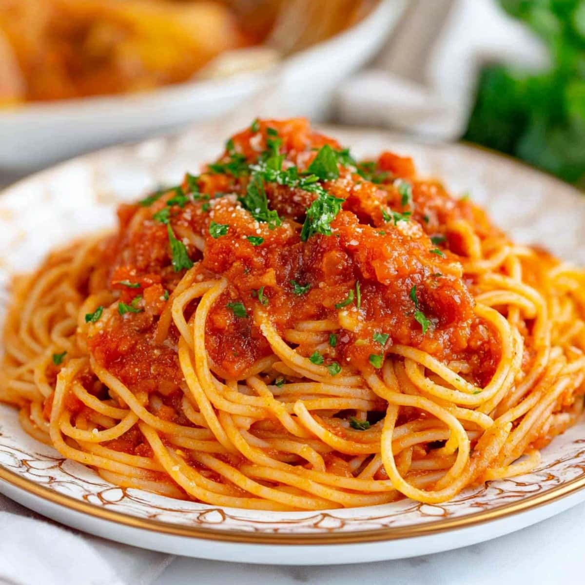 A platter of spaghetti arrabbiatia served in a chinese plate.