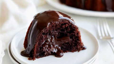 A delicious slice of tunnel fudge cake, drizzled and filled with chocolate sauce.