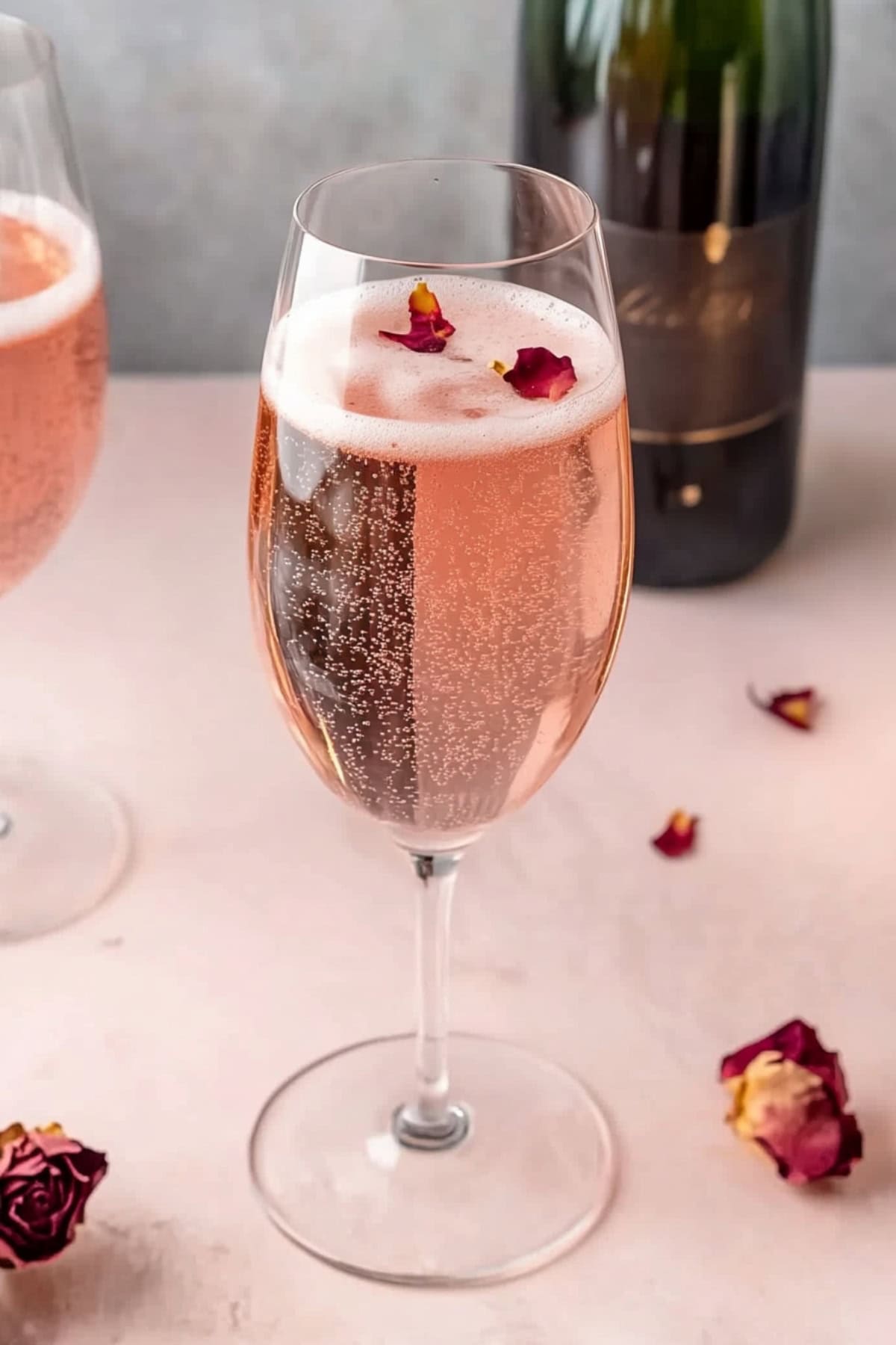 Sparkling pink Valentine's day cocktail with raspberry syrup and pink ginger soda with dried rose petals.