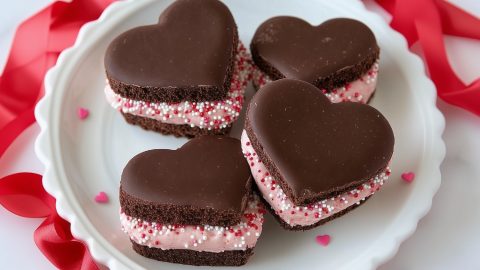 Chocolate sandwich cookies with creamy filling and candy sprinkles perfect for Valentine's Day.