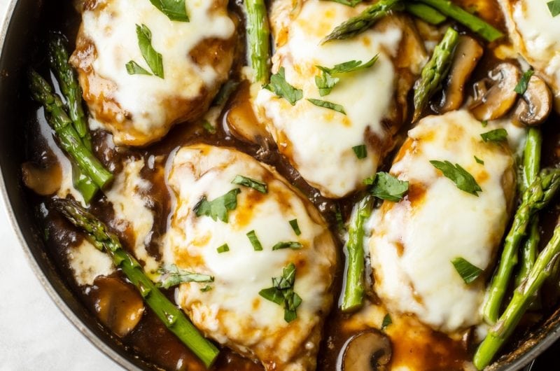 A close-up of chicken Madeira with wine and mushroom sauce in a skillet.