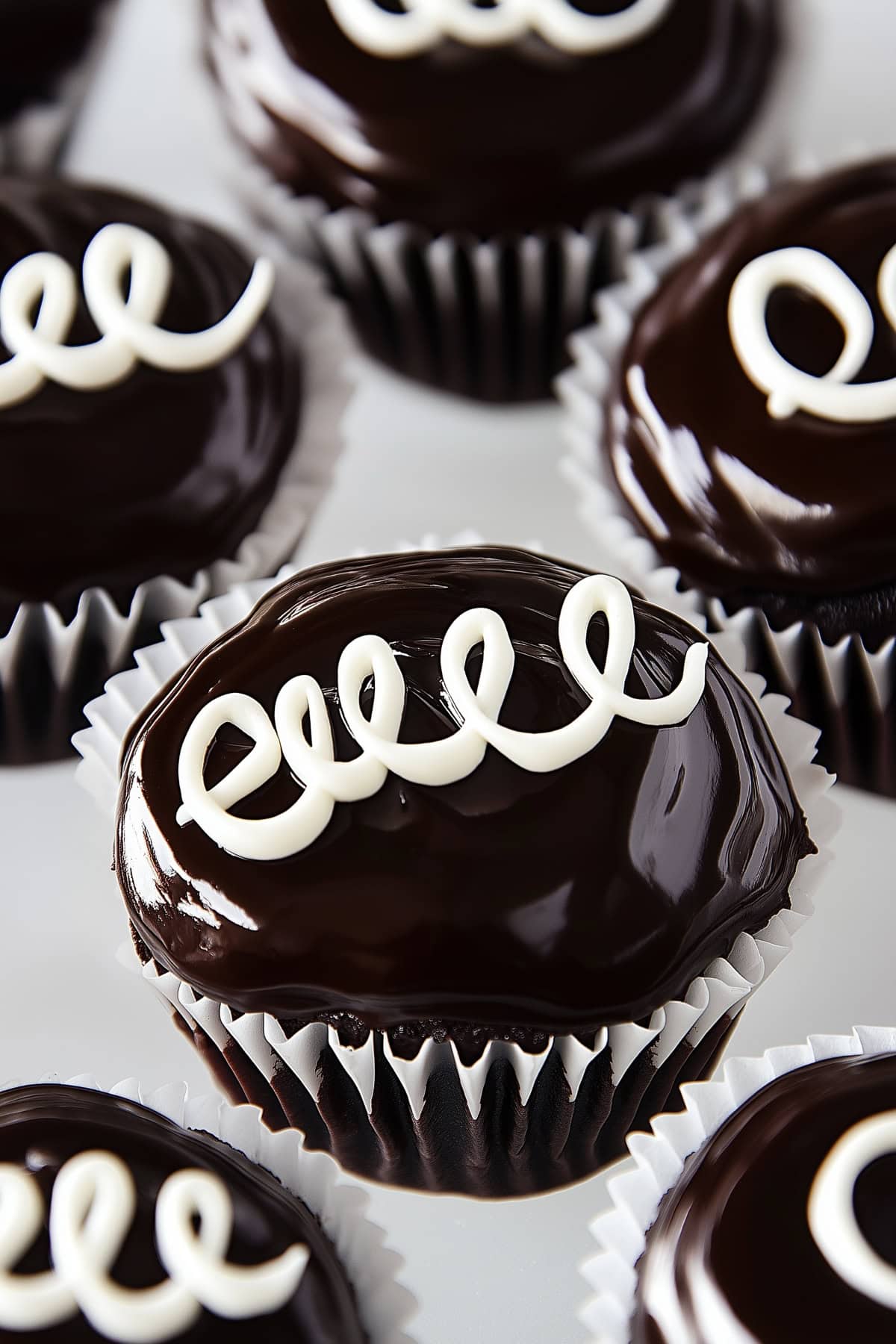 Moist chocolate cupcake covered with chocolate ganache finished with swirl on top.