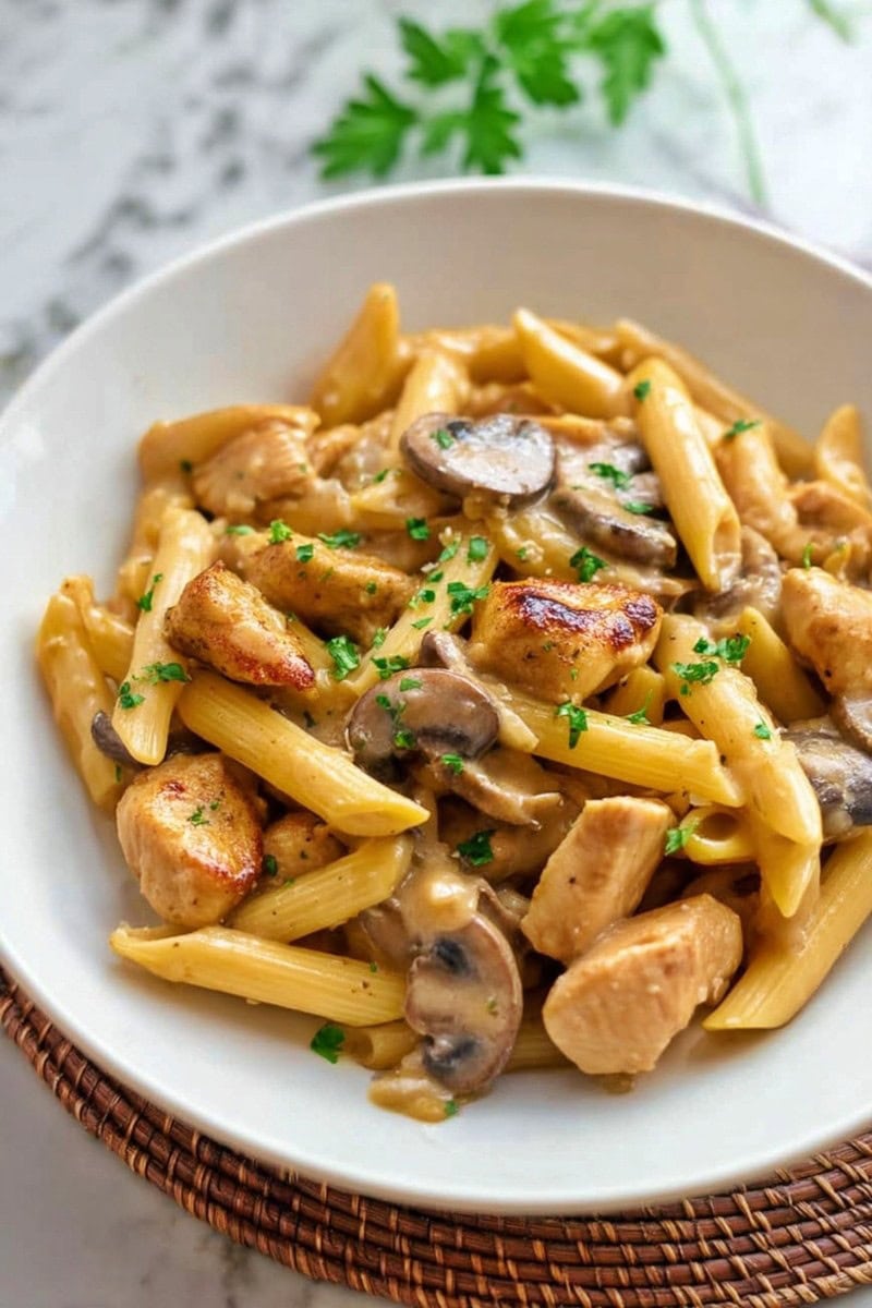 A bowl of Pasta Da Vinci garnished with chopped parsley