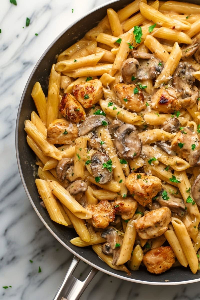 Pasta Da Vinci topped with parmesan in a skillet 