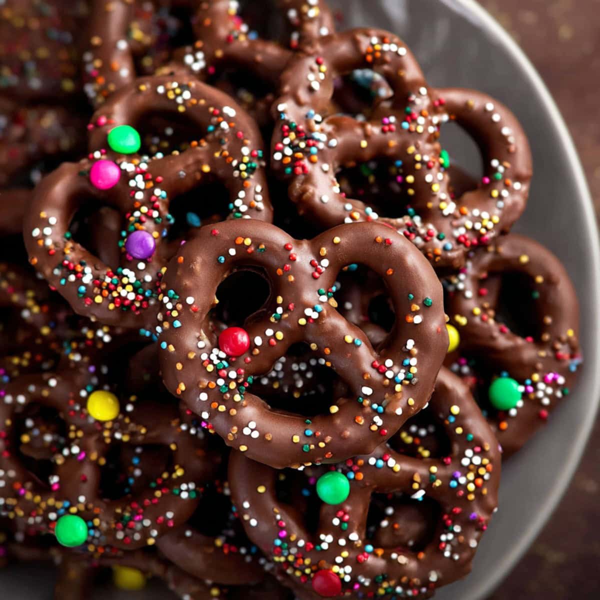 Chocolate covered pretzels with candy sprinkles.