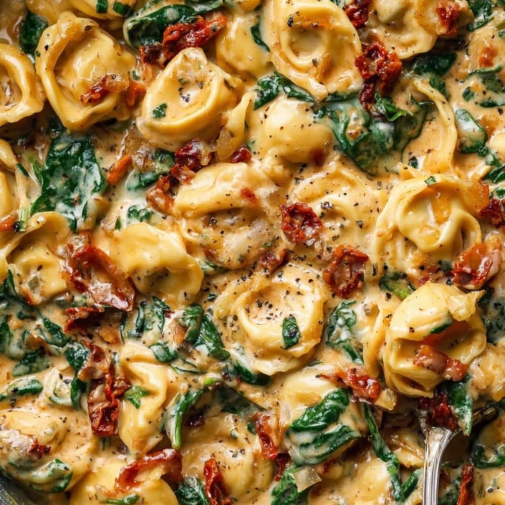 Marry Me Tortellini with sun-dried tomatoes and spinach, close-up shot.