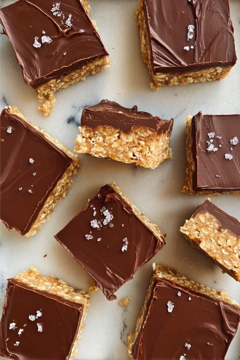 Oh Henry Bars on a marble table, topped with flaky sea salt.