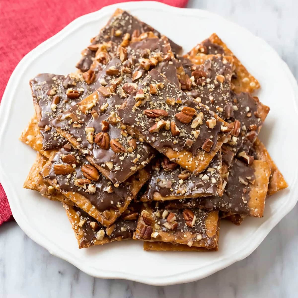 Chocolate toffee crack with saltine crackers and crushed nuts.