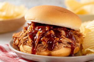 Slow cooker texas pulled pork with BBQ Sauce, served with chips